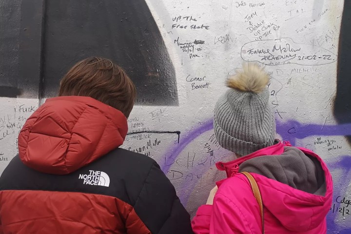 a couple of people that are standing in the rain