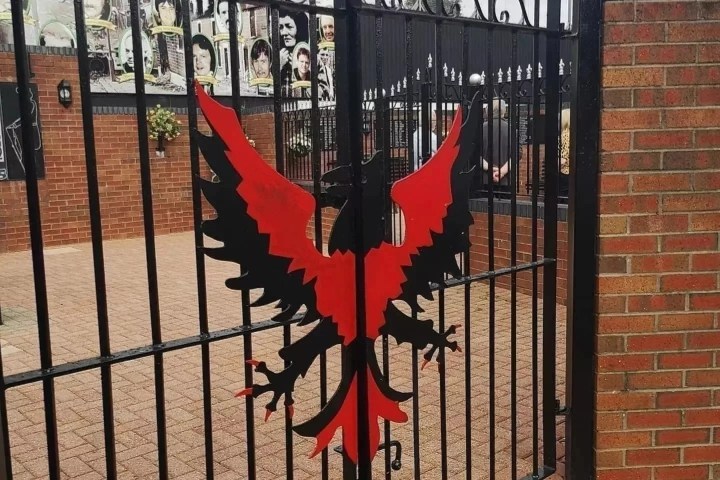 a gate in front of a brick building