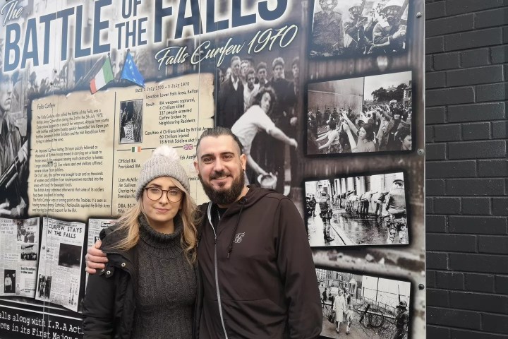 a group of people standing in front of a sign