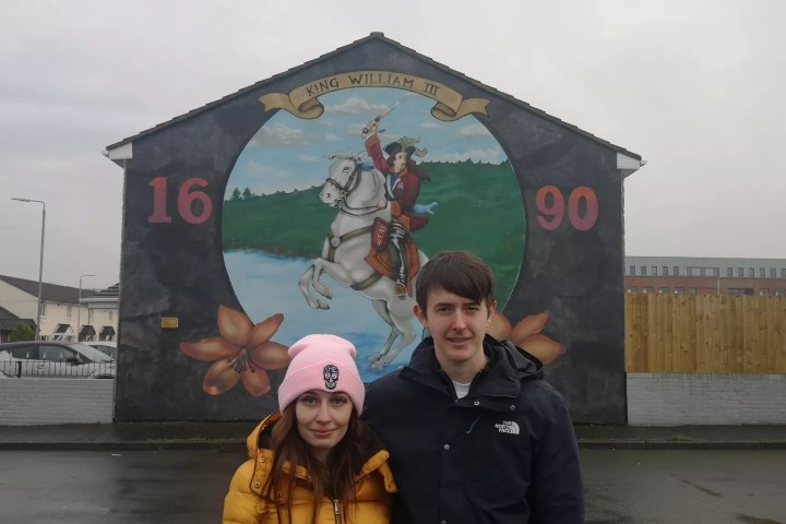 a man standing in front of a building