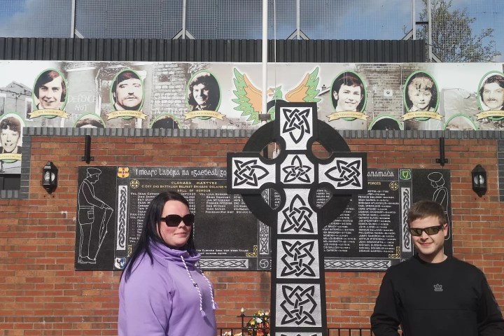 a group of people posing for a photo in front of a building
