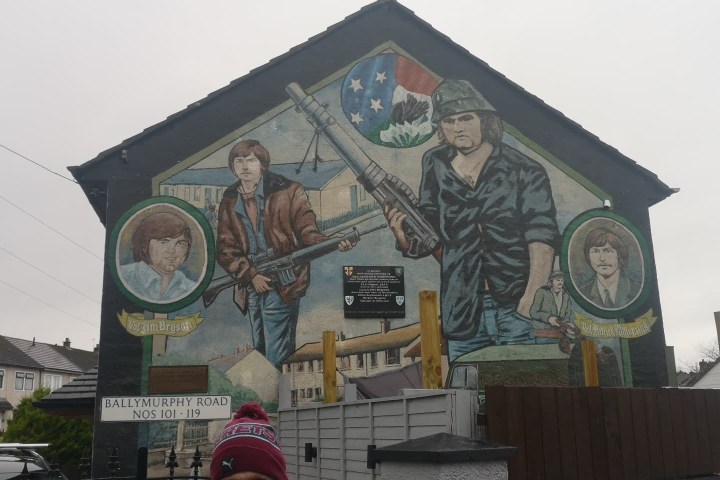 a man standing in front of a building
