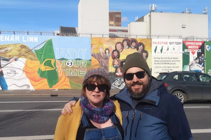 a man holding a sign posing for the camera