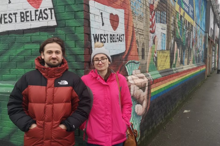 a group of people holding a sign posing for the camera