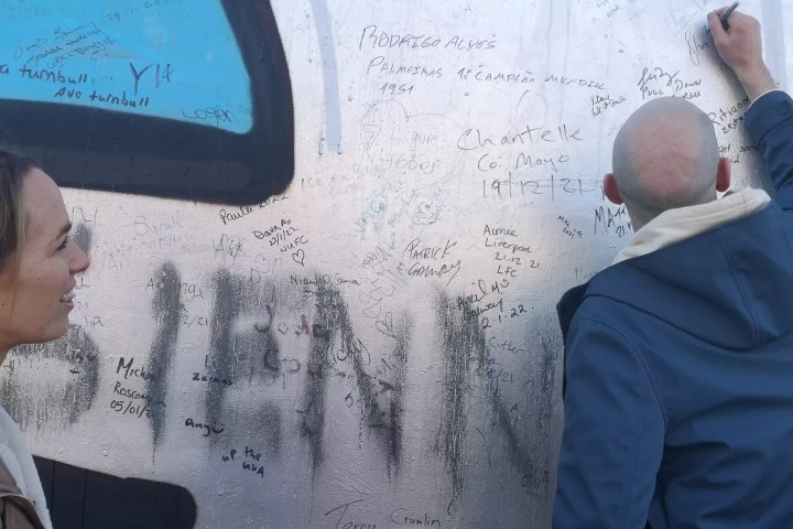a man standing in front of a mirror posing for the camera