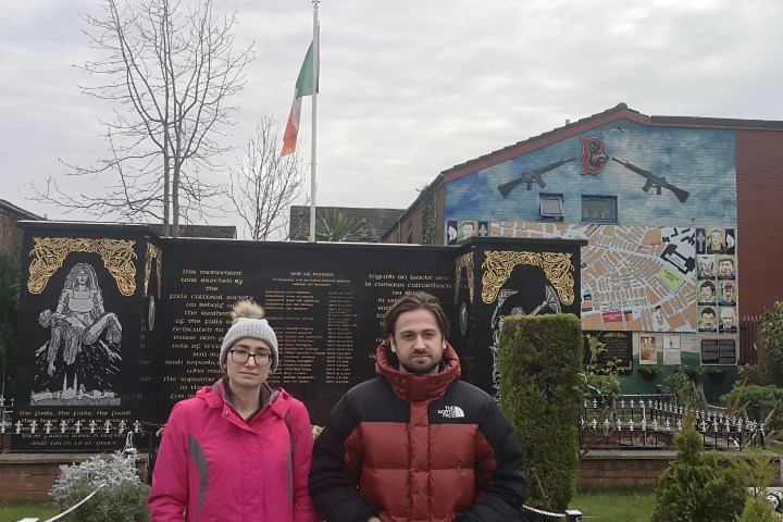 a man and a woman standing in front of a building