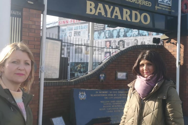 a woman standing in front of a building